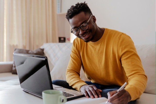 Man writing in notebook 