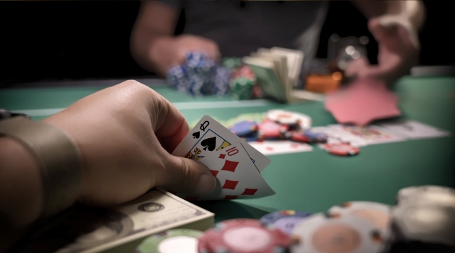 Hand holding cards during poker game