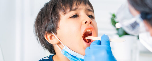 Kid being checked out by a doctor